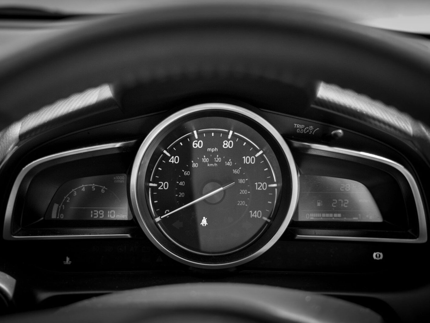 black and white car speedometer